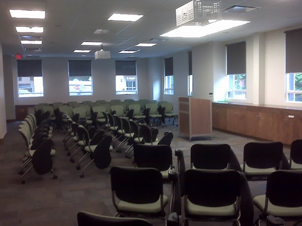 large room with chairs surrounding a lectern