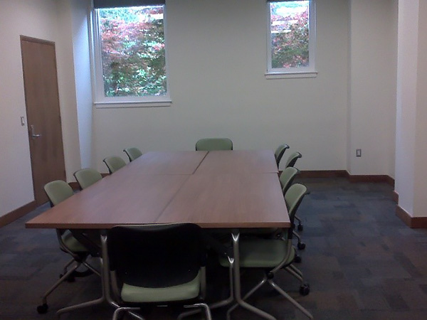 small room with a conference table and chairs